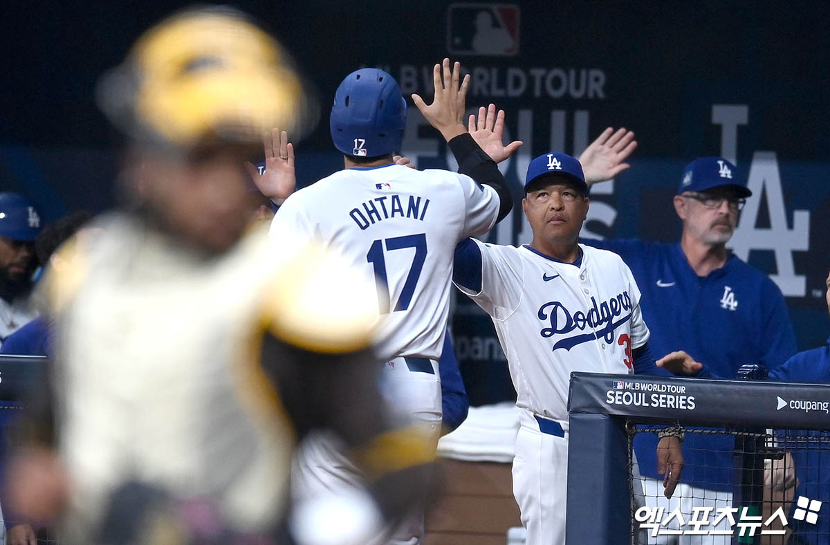 21일 오후 서울 구로구 고척스카이돔에서 열린 '메이저리그(MLB) 월드투어 서울시리즈 2024' LA 다저스와 샌디에이고 파드리스의 경기, 1회말 1사 1,2루 LA 다저스 안타 때 2루주자 오타니가 득점에 성공한 후 더그아웃으로 향하며 로버츠 감독과 하이파이브 하고 있다. 엑스포츠뉴스 DB