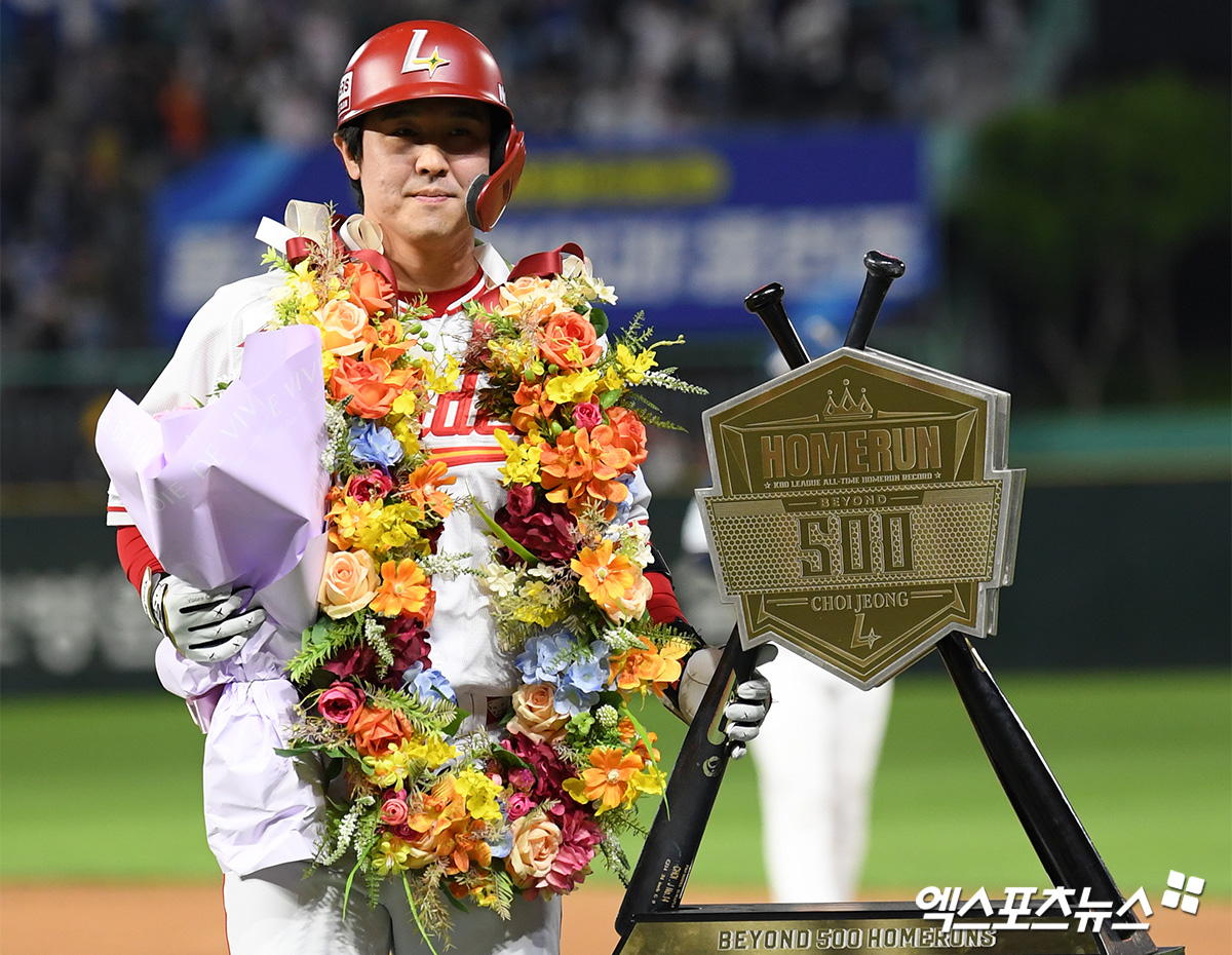 SSG 타자 최정이 13일 인천 미추홀구 SSG랜더스필드에서 열린 '2025 신한 SOL 뱅크 KBO리그' NC 다이노스와의 홈 경기에서 6회 투런포를 때려 KBO리그 사상 처음으로 개인 통산 500 홈런을 기록한 뒤 시상식에서 화환을 목에 걸고 기념패를 옆에 세운 채 기념촬영에 응하고 있다. 문학, 고아라기자