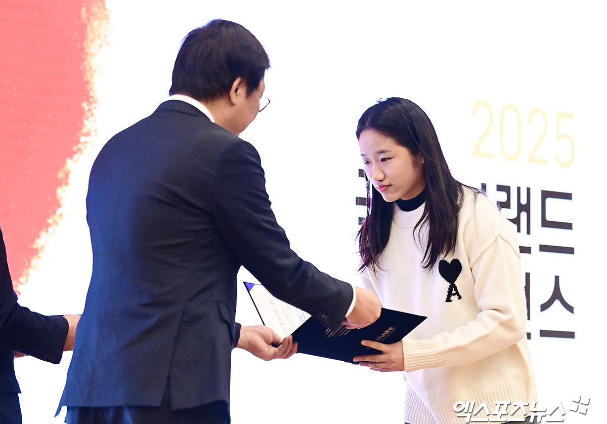 안세영(오른쪽)이 30일 서울 여의도 국회도서관 대강당에서 열린 '2025 국가브랜드 컨퍼런스'에서 최휘영 문화체육관광부 장관에게 '글로벌 스포츠 리더십' 부문 상장과 트로피를 받고 있다. 사진 박지영 기자 