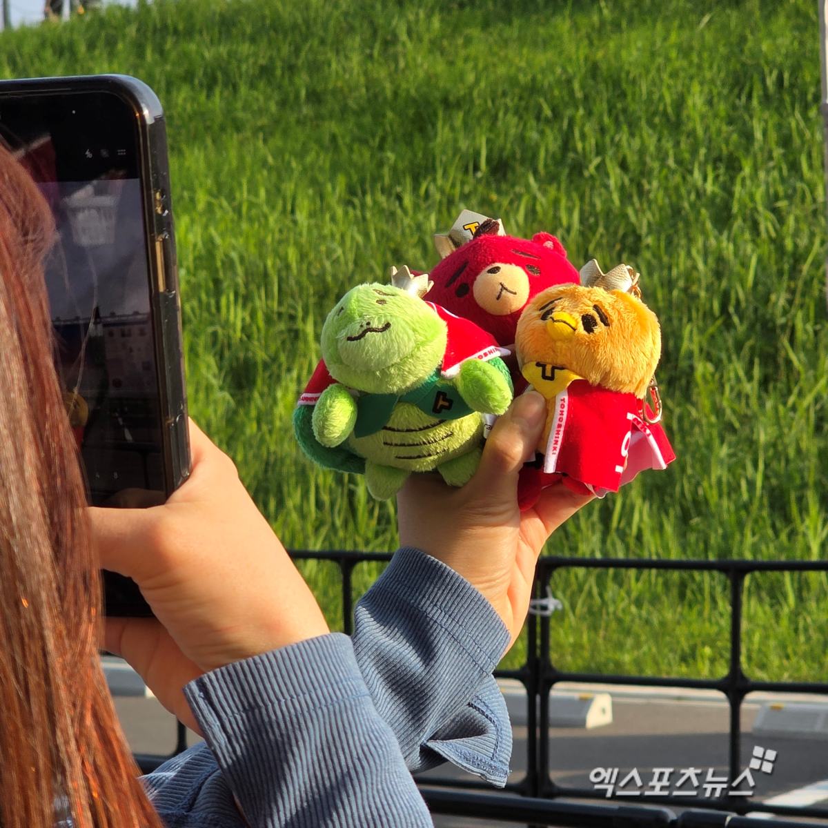 Fans taking photos in front of goods banner