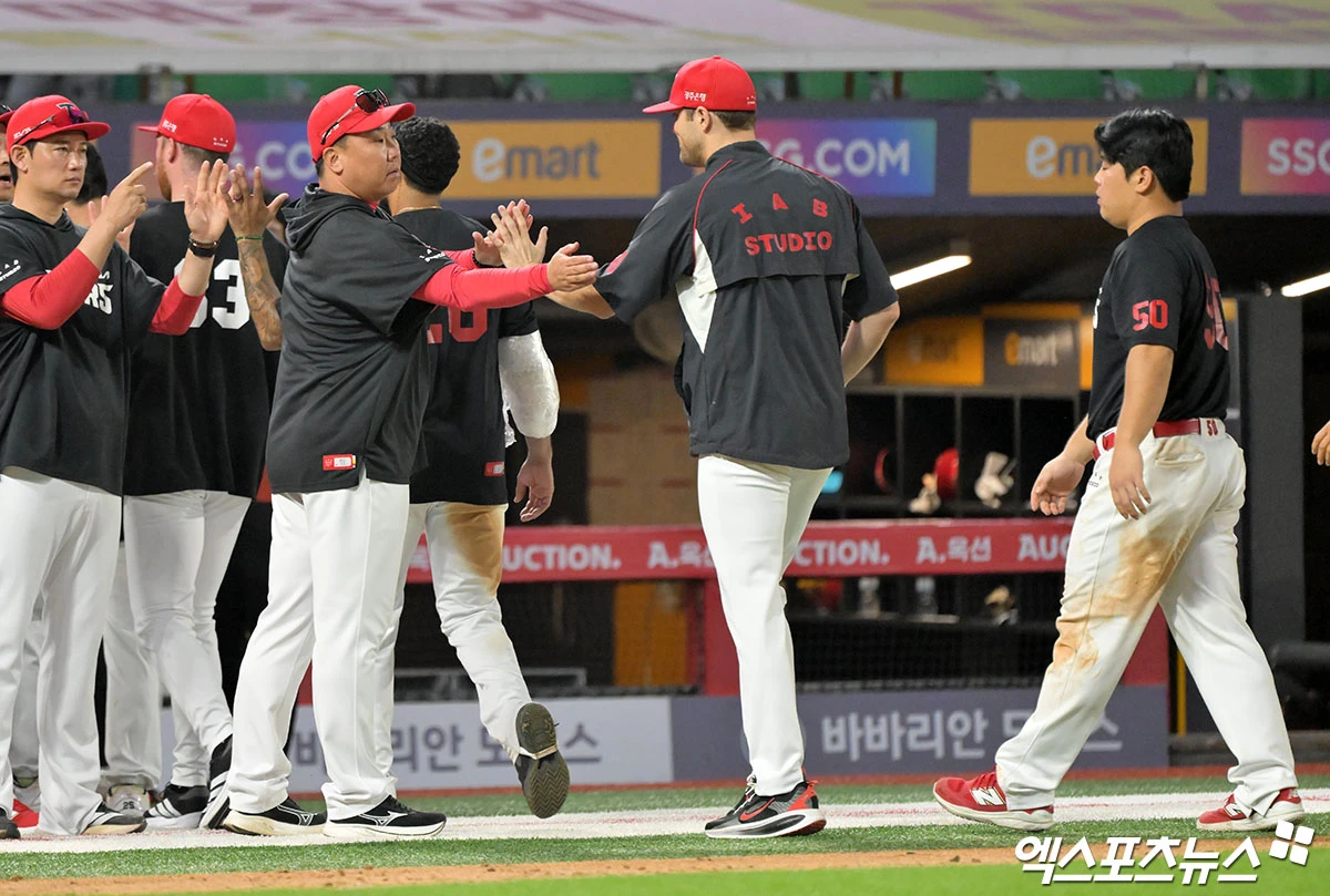 18일 오후 인천SSG랜더스필드에서 열린 '2026 신한 SOL Bank KBO리그' KIA 타이거즈와 SSG 랜더스의 경기, KIA가 18안타를 몰아치며 SSG에 12:2 대승을 거뒀다. 이날 경기에서 승리한 KIA 이범호 감독이 선수들과 하이파이브를 하고 있다. 인천, 김한준 기자